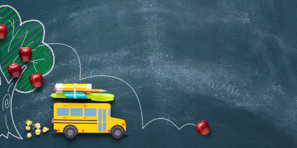 An illustration of a school bus and apples.