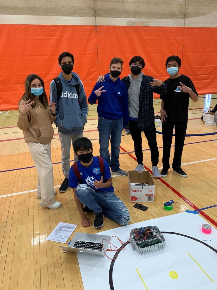 Students posing with sumobot.